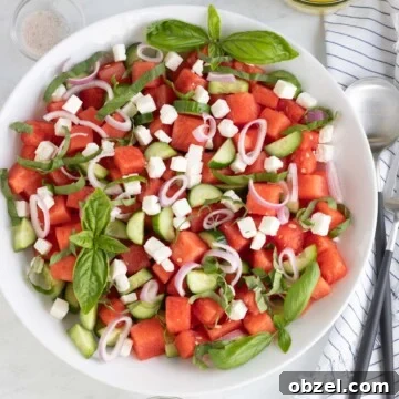 Watermelon salad ready to serve with cucumber, feta, basil, and shallots.