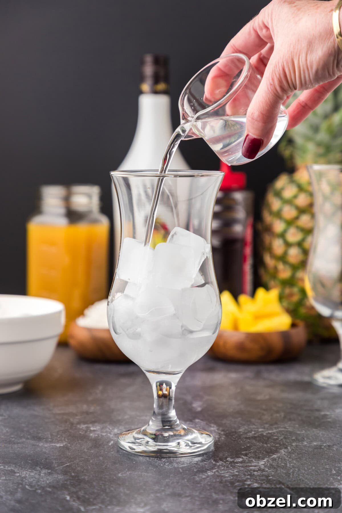 Malibu Sunset: Where to Watch, Photograph and Enjoy 6 pouring coconut rum into glass of ice