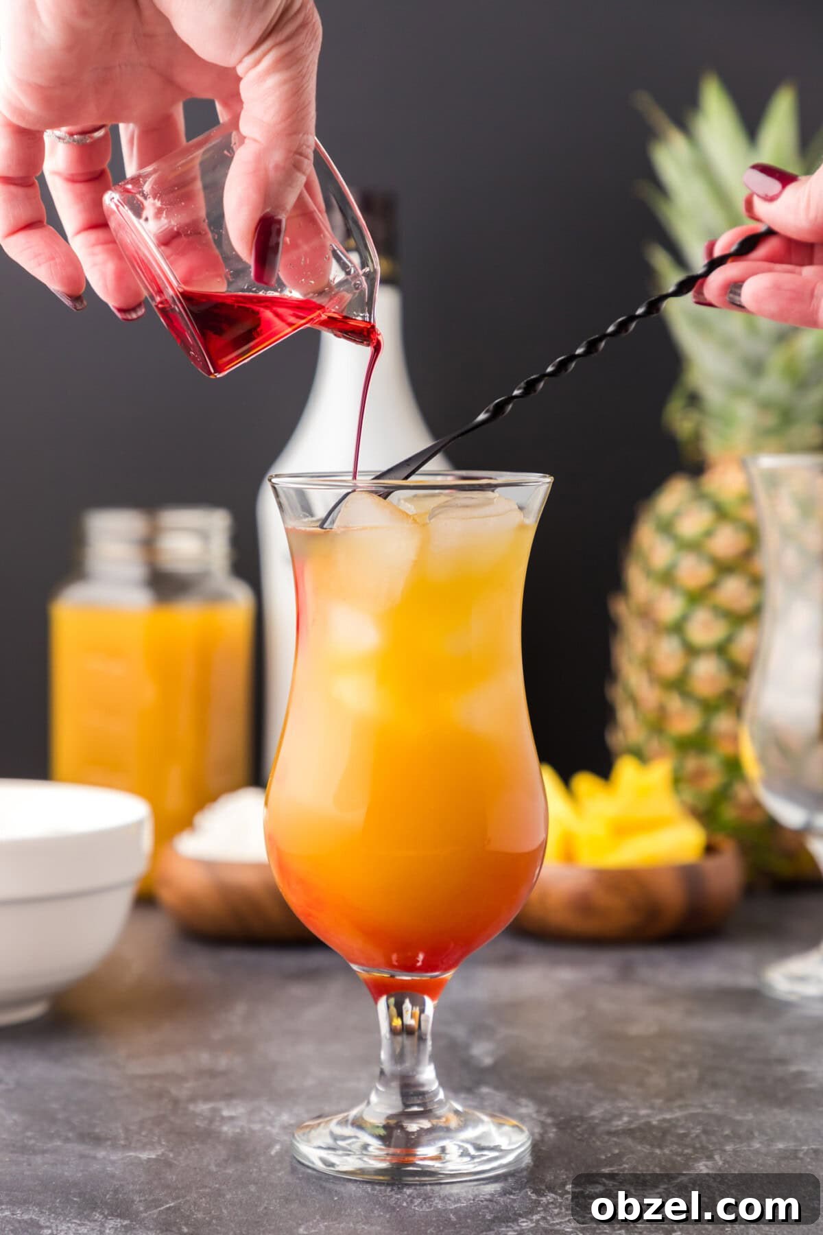 Malibu Sunset: Where to Watch, Photograph and Enjoy 8 carefully pouring grenadine over a cocktail spoon into malibu sunset