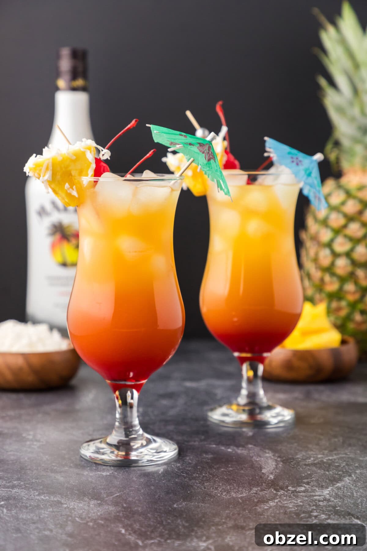 Malibu Sunset: Where to Watch, Photograph and Enjoy 9 Malibu sunset cocktails with pineapple wedge and shredded coconut garnish
