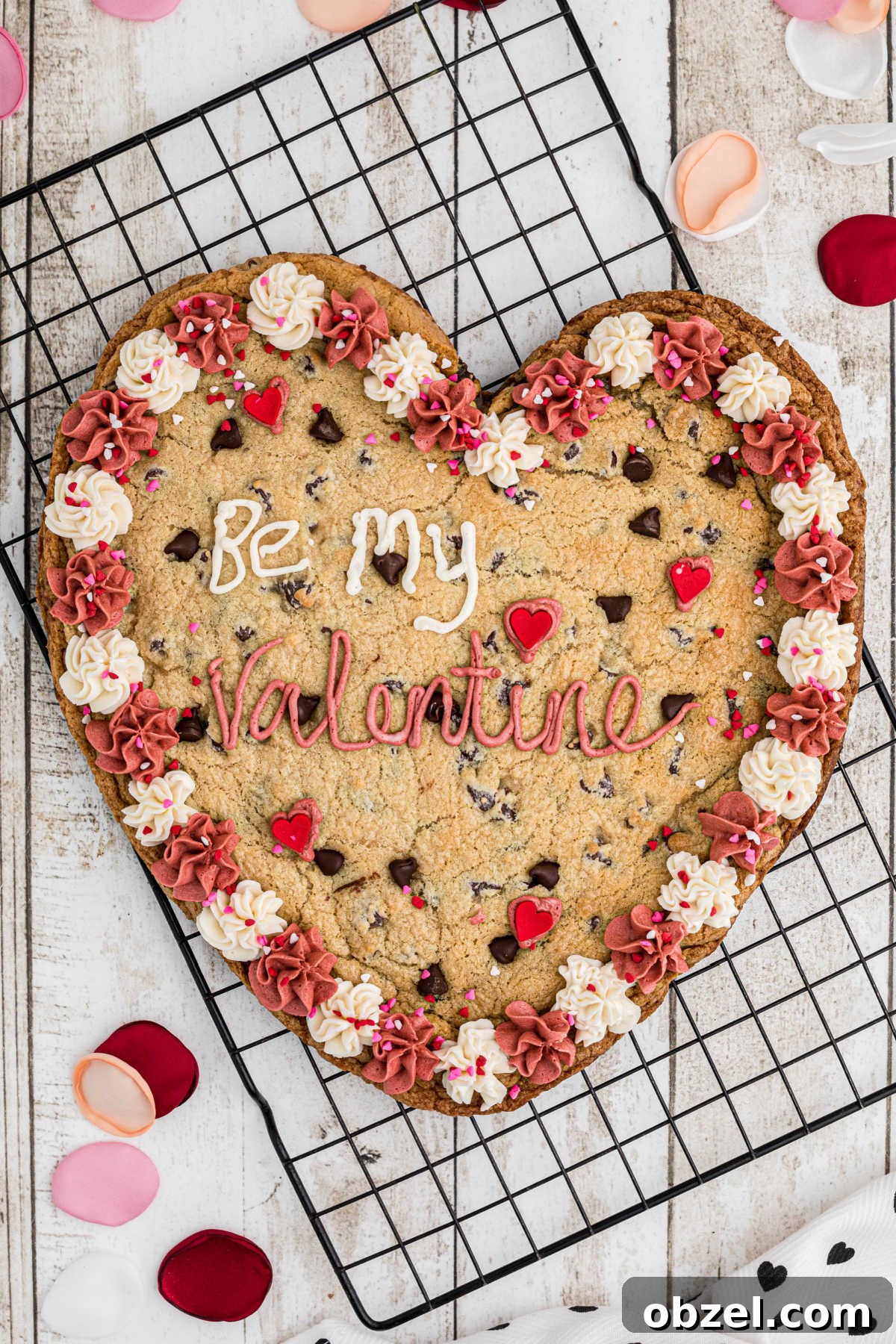 An overhead shot of a giant valentines cookie on a cooling rack.