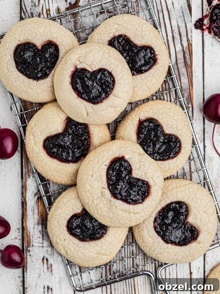 A wire rack over a piece of white wood with a pile of tiktok jam heart cookies.